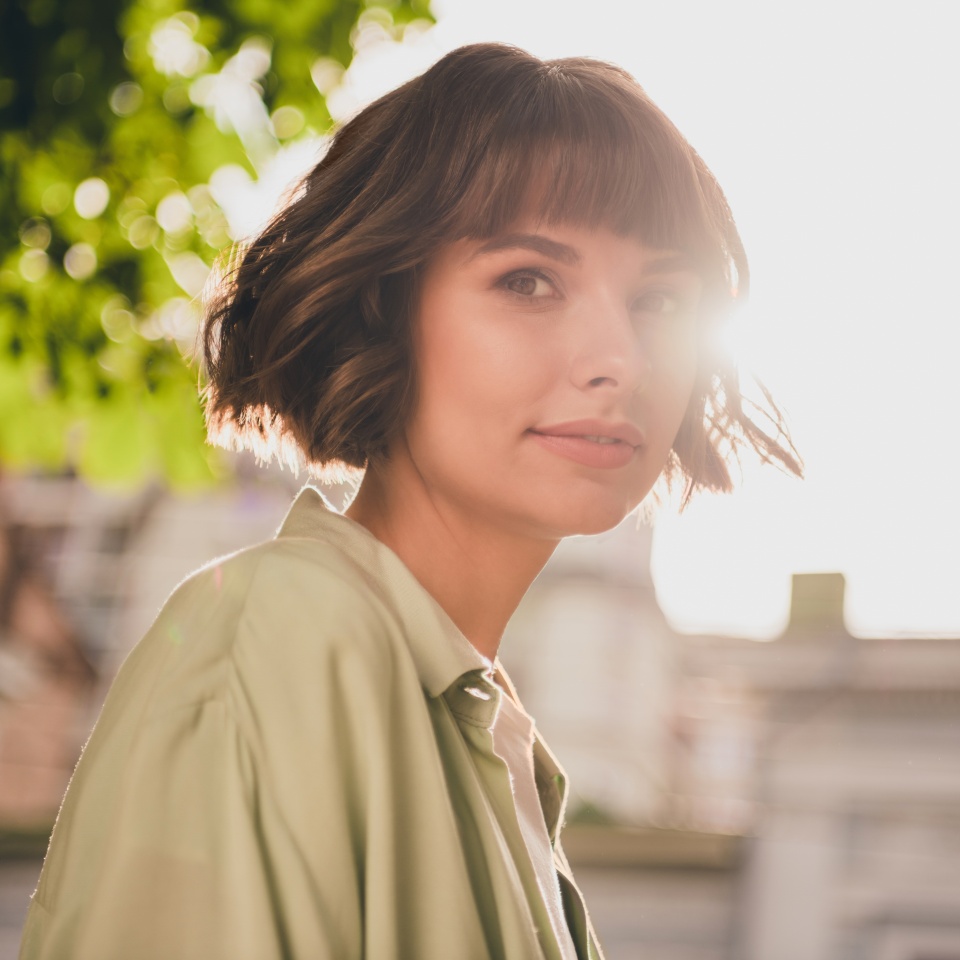 Photo of cute charming young woman wear green shirt rucksack smiling walking outside city street