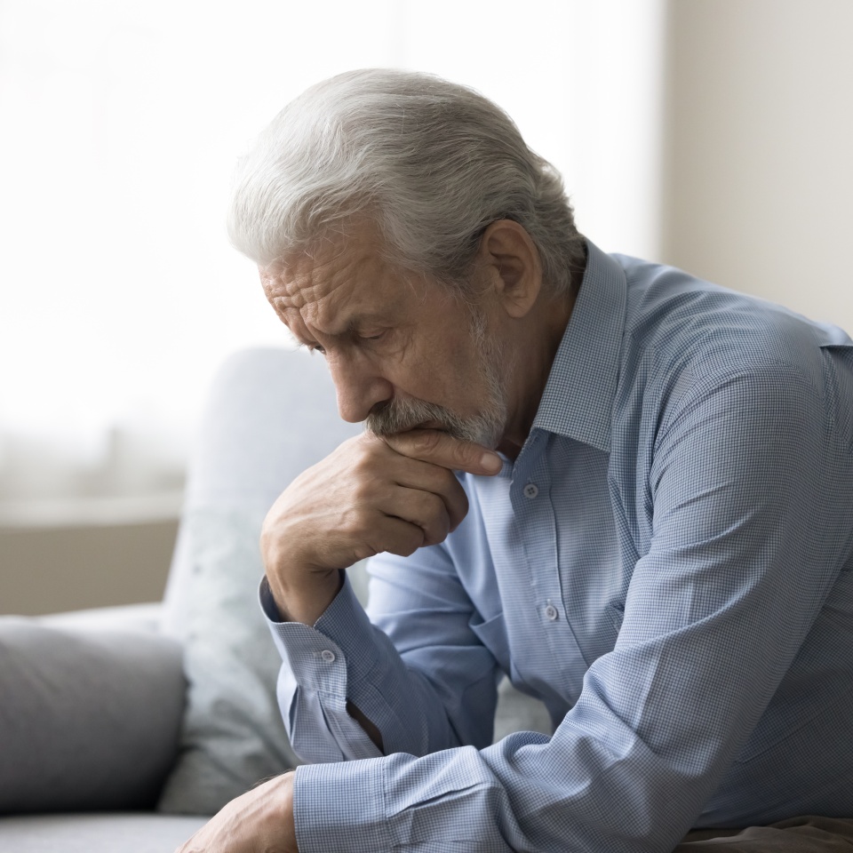 Sad lonely grey haired old man thinking on geriatric health problems, bored retirement at home, feeling sick, tired, suffering from depression, memory loss, mental disorder