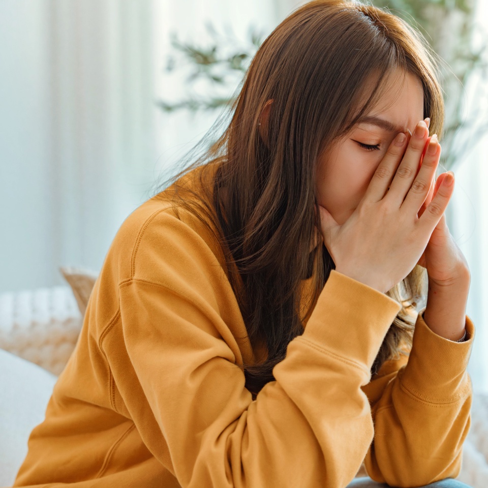 Sad tired young asian woman touching forehead having headache migraine or depression, upset frustrated girl troubled with problem feel stressed, Grief sorrow concept
