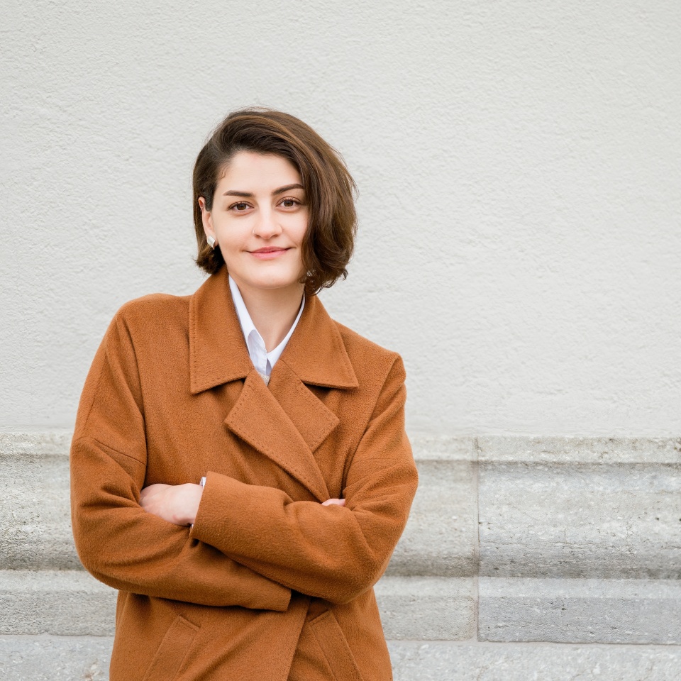 Smiling woman in coat on street