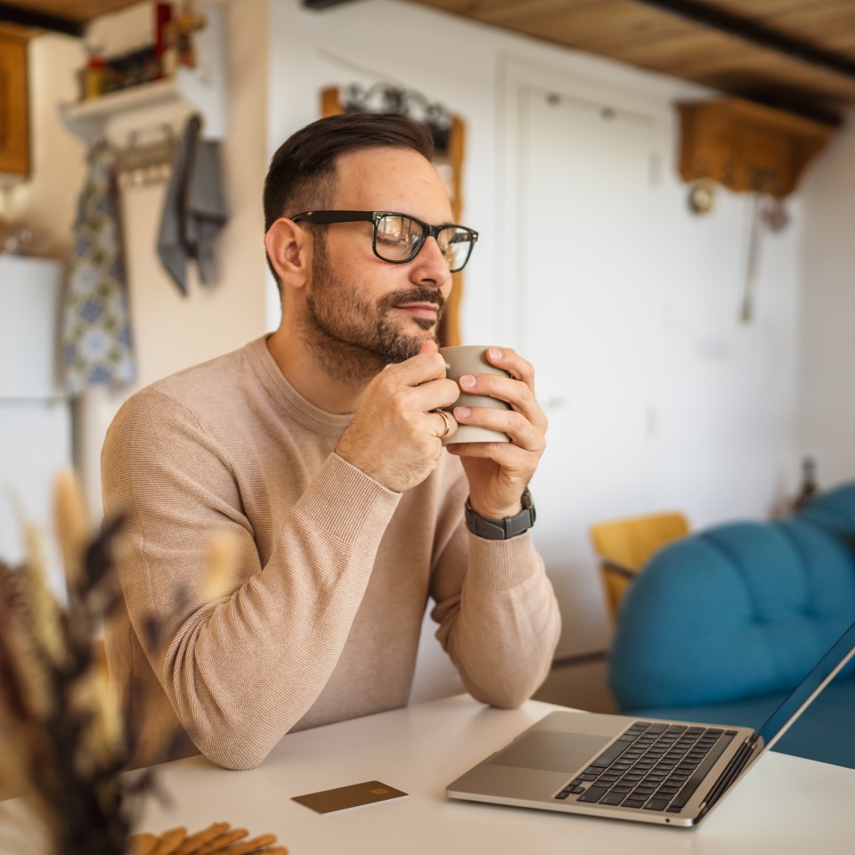 Portrait of adult caucasian man sit at home and hold cup of coffee enjoy and relax at kitchen