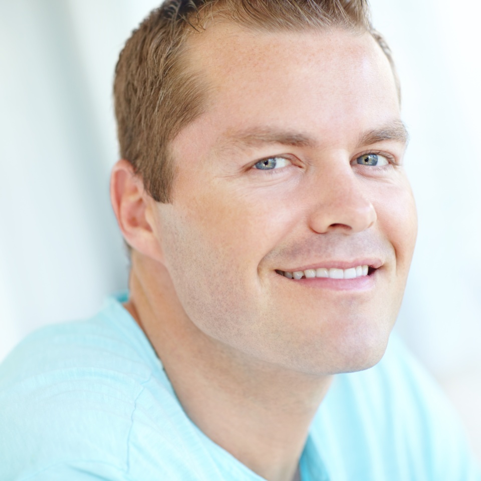 Smile, relax and portrait of man in home with positive attitude, chilling or resting in living room. Happy, calm and face of male person from Germany with confidence and pride in lounge at apartment.